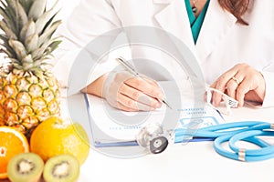 Nutritionist writing medical records and prescriptions