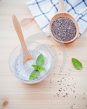 Nutritious chia seeds museli and peppermint leaves with wooden