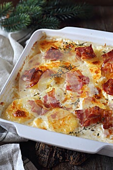 Nutritious winter dish. Potato gratin with bacon