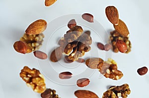 Nuts in the air on a white background, flying nuts. Healthy Brain Food, Diet, Protein, Almonds, walnuts and hazelnuts