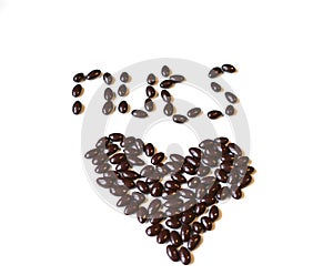 Nuts arranged in heart shape on background. Food image close up candy, chocolate milk, extra dark almond nuts. Love Texture on