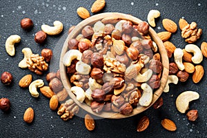 Nuts assortment at black background.