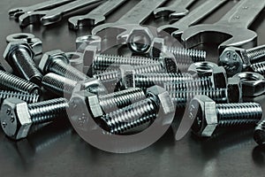 Nuts, bolts and keys on a metal surface.