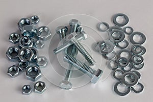 Nuts, bolts and washers on white background