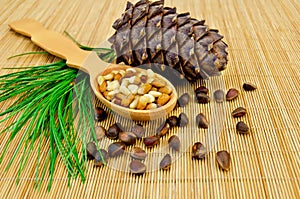 Nuts and cone of cedar on a bamboo mat