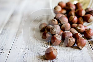 Nuts of different shapes on wooden white background