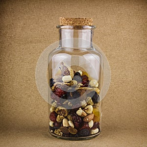 Nuts and dried fruit mix in a glass jar