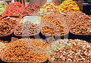 Nuts and dried fruits on the market, sweets on the counter