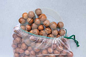 Nuts in eco-friendly packaging. Reusable bags for vegetables and fruits. Shopping in the store. Eco-friendly packaging. Caring for