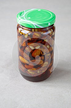 Nuts in honey in a glass jar