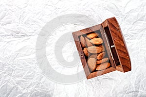 nuts snack salted almonds on white baking paper top view