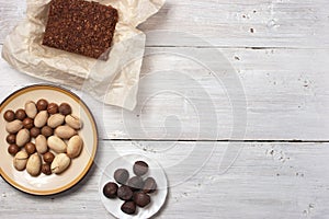 Nuts, truffle candy and chocolate cake on the white background