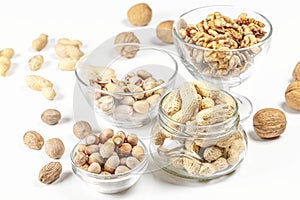 nuts that are on a white surface, some without shell and others