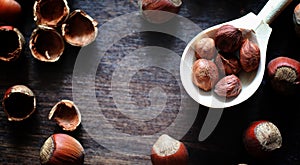 Nuts on a wooden table.Hazelnuts in the shells and shelled. A wo