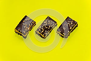 Nutty brownie bars on a yellow background