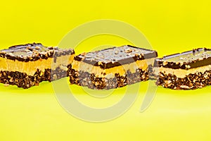 Nutty brownie bars on a yellow background