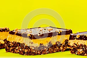 Nutty brownie bars on a yellow background. Dream bar