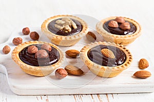 Nutty dessert - small tarts with different nuts and chocolate