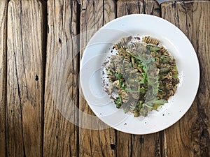 Nutty Fusilli Italian pasta with chicken, vegetables, Arugula and pesto sauce.  Gluten free dish. Flat lay.  Top view