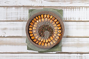 Nutty gluten-free cake with apricot nuts with filling  on green napkin  on a light wooden background