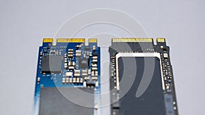 NVME M2 SSD disks for data storage at high speed closeup on isolated background. Comparision view focused at the pinpoint.