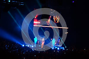 NXT male wrestler Adrian Neville knells and points into the air