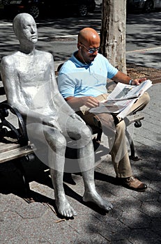 NYC: Man Reading Newspaper & Sculpture