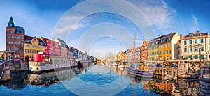 Nyhavn canal with boats, ships and many small colorful houses. Copenhagen, Denmark