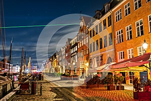 Nyhavn at night during Covid 19 pandemic. Pubs and bars are closed, the old harbour is deserted conveying a surreal atmosphere