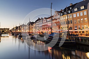 Nyhavn water front canal and touristic street at night photo