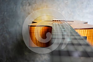 Nylon classical guitar neck and body on concrete background