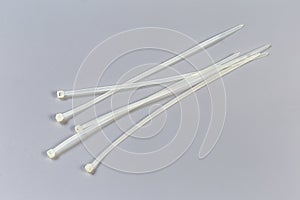 Nylon unfastened translucent cable ties on a gray background