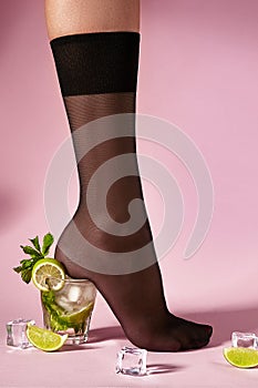 Nylons, stay-up, tights, hosiery, hose, pantyhose socks summer collection on pink background as a heel creative a glass of