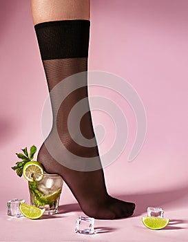 Nylons, stay-up, tights, hosiery, hose, pantyhose socks summer collection on pink background as a heel creative a glass of photo
