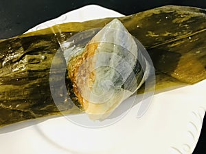 Nyonya Chang, glutinous rice dumpling on pandan leaves.