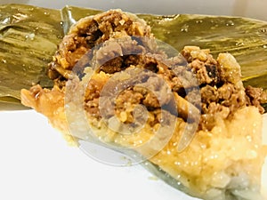 Nyonya Chang, glutinous rice dumpling with pandan leaves. select focus. Melaka food concept.