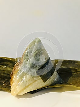 Nyonya Chang, glutinous rice dumpling on pandan leaves. Vertical photo image.