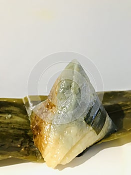 Nyonya Chang, glutinous rice dumpling with pandan leaves. Vertical photo image.