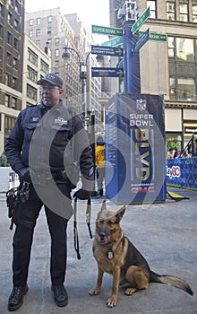 NYPD transit bureau K-9 police officer and K-9 German Shepherd providing security on Broadway during Super Bowl XLVIII week