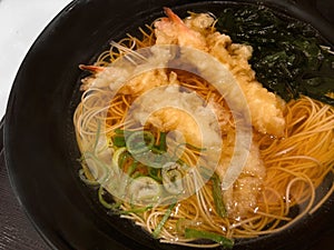 Nyumen or hot somen noodles with shrimp tempura, seaweed and sliced Japanese bunching onion