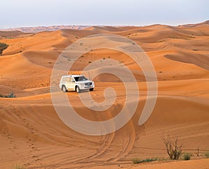 19.11.2017, OAE, Bashing safari on car in red desert. Sunset and dune