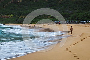 Oahu beach with big waves and many people on sand