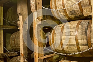 Oak bourbon barrels on rack in warehouse