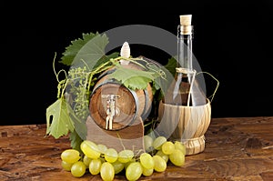 In oak casks with vines and grapes white and black