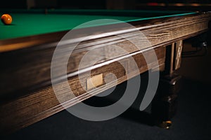 The oak decorative leg of a billiard table looks expensive