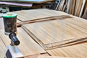 Oak veneer. Oak texture. Veneer splicing process with veneer hand splicer in woodshop photo