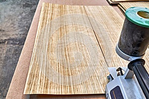 Oak veneer. Oak texture. Veneer splicing process with veneer hand splicer in woodshop photo