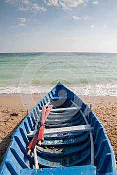 Oar boat on beach photo