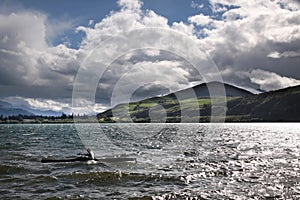 Oarsman on Lake Hayes on a stormy day