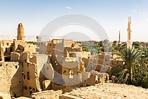 Oasis, ruins of ancient middle eastern Arab town built of mud bricks, old mosque, minaret. Al Qasr, Dakhla, Western Desert, Egypt.